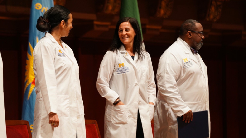 doctors in white coats standing next to each other