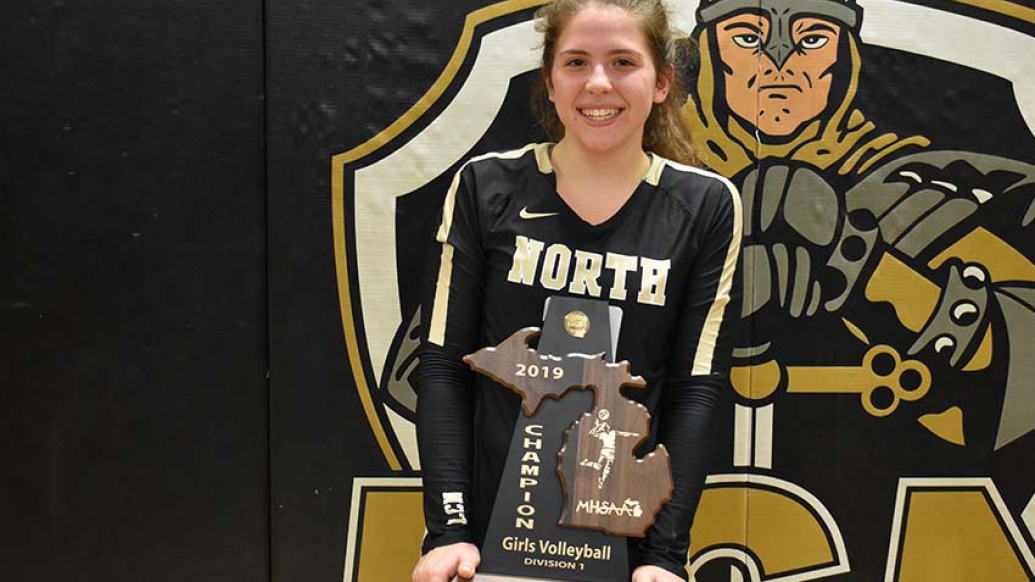 Emily posing with volleyball trophy