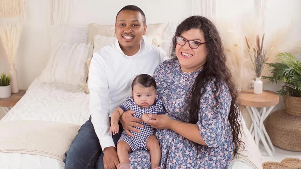 Couple sitting together with baby on lap
