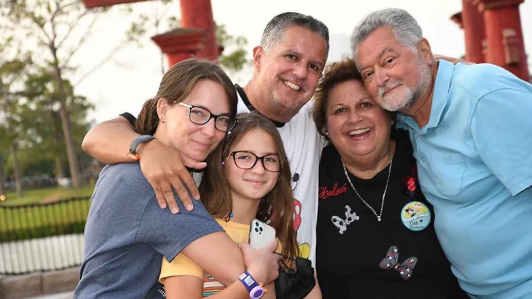 family smiling posing outdoors happy