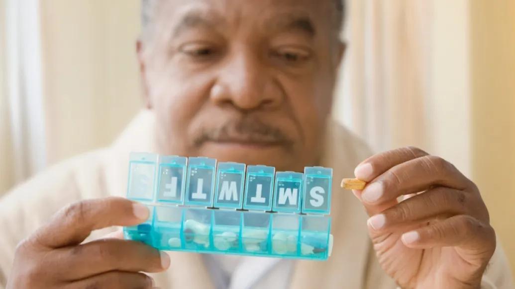 Man holding a pill box