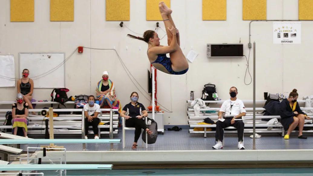 Girl doing a dive into swimming pool