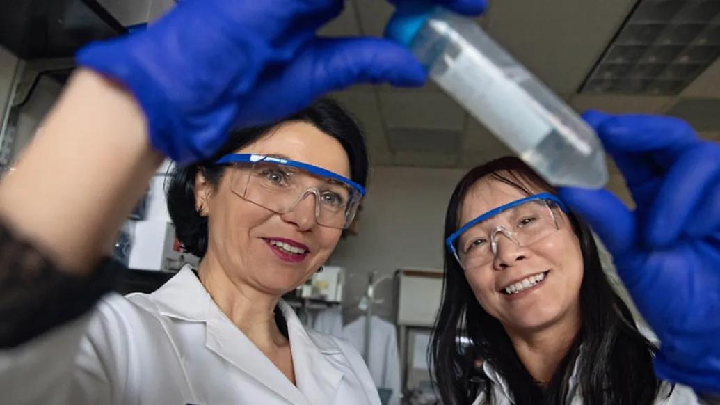 Researchers looking at vial
