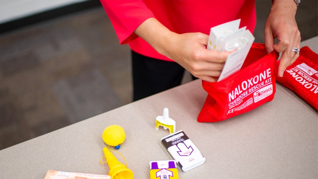 hands in red bag with medication naloxone