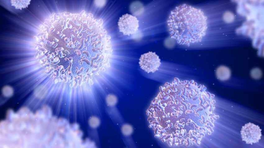 purple-blue cells floating around on dark background
