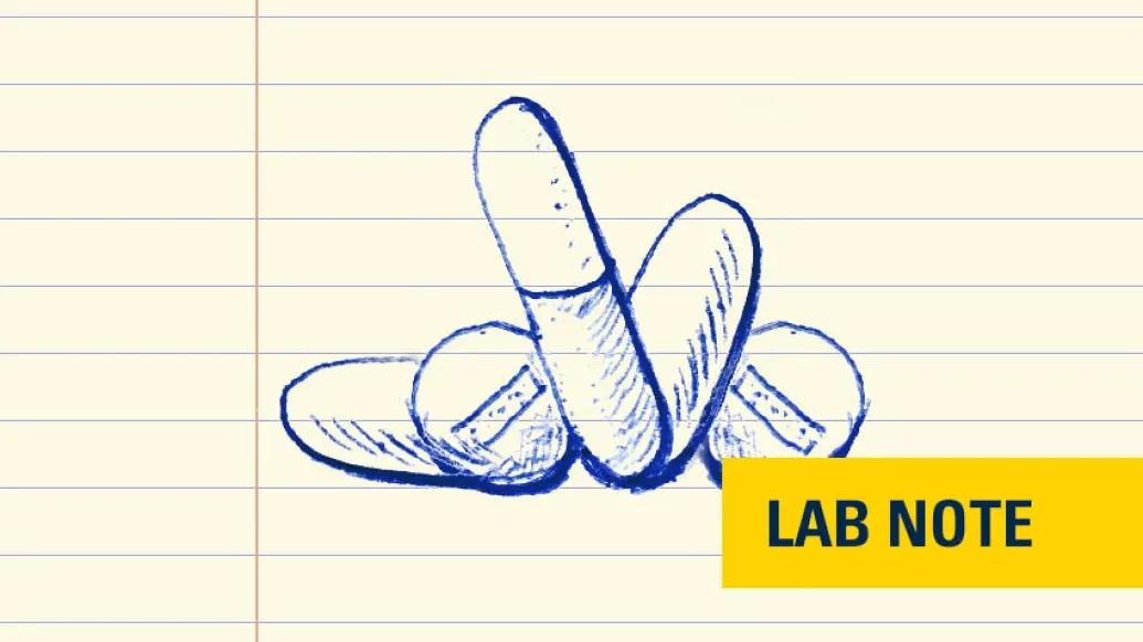 drawing of pills in blue ink with lab note written on bottom right in yellow and navy blue