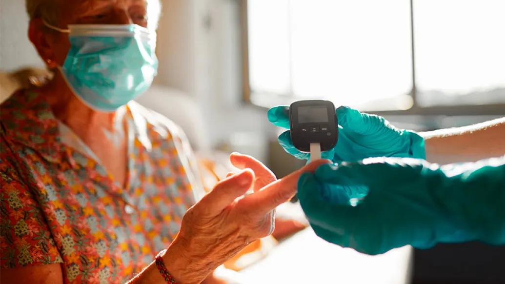  Masked Woman Blood Glucose Check