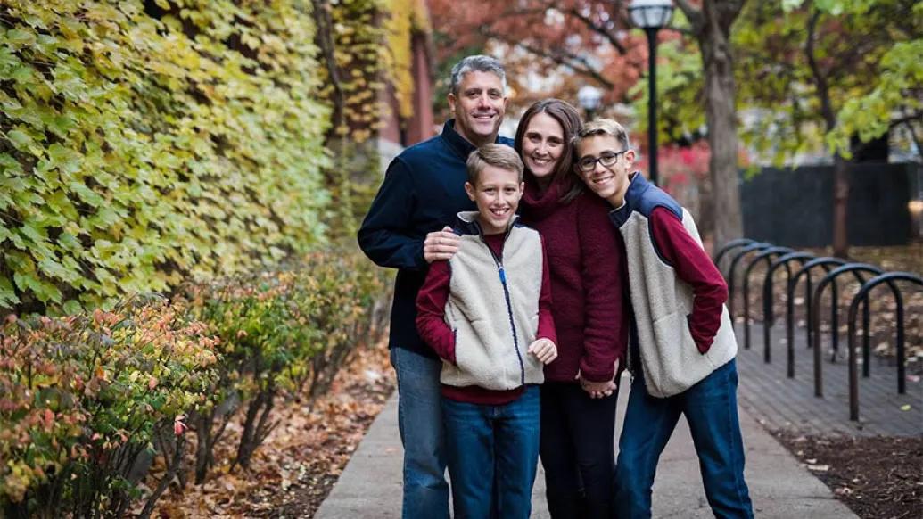 The Bergquist family on a path with autumn trees behind them.