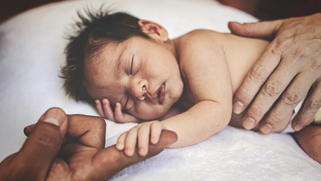 newborn baby sleeping hands blanket