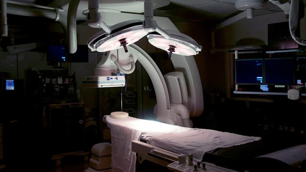 operating room in dark room with dramatic lights over operating table