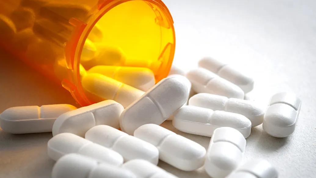 pills spilling out orange bottle