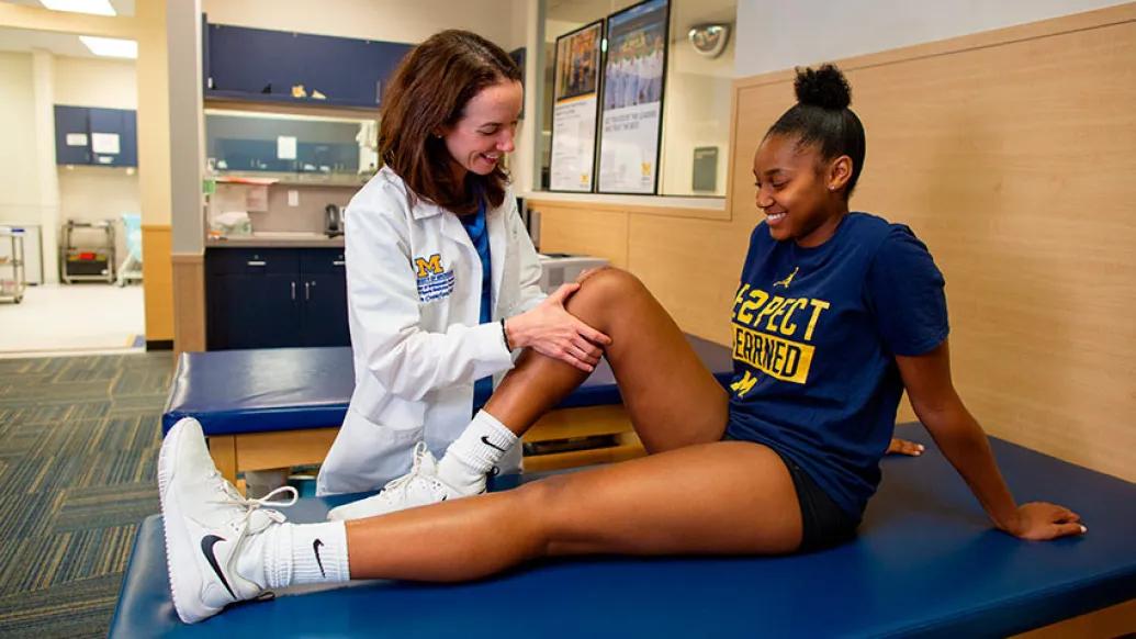 Provider doing leg stretching exercises on athlete