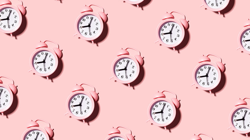 pink old school alarm clock in repetitive pattern