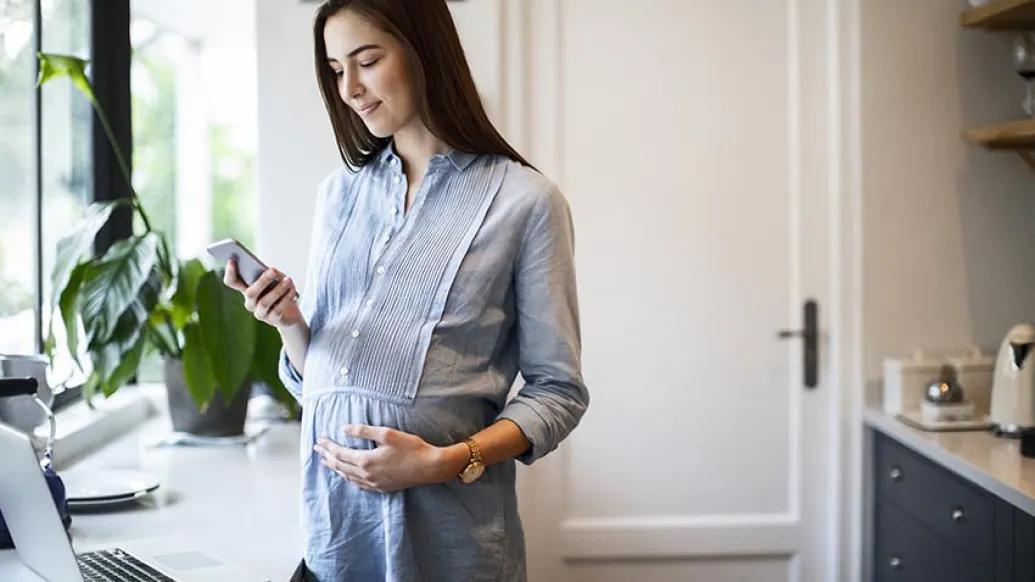 Pregnant lady using technology to check in with doctor