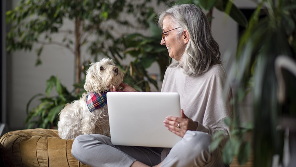 senior woman sitting with dog on lap