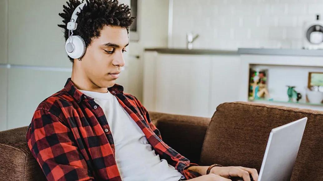 Student on laptop at home on couch