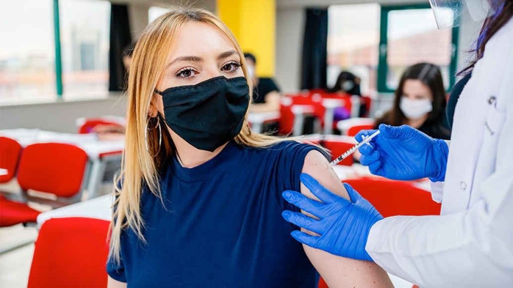 ten girl getting vaccine in arm