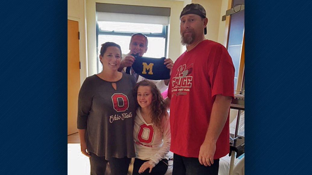 Olivia and her family of Ohio State fans with their U-M doctor