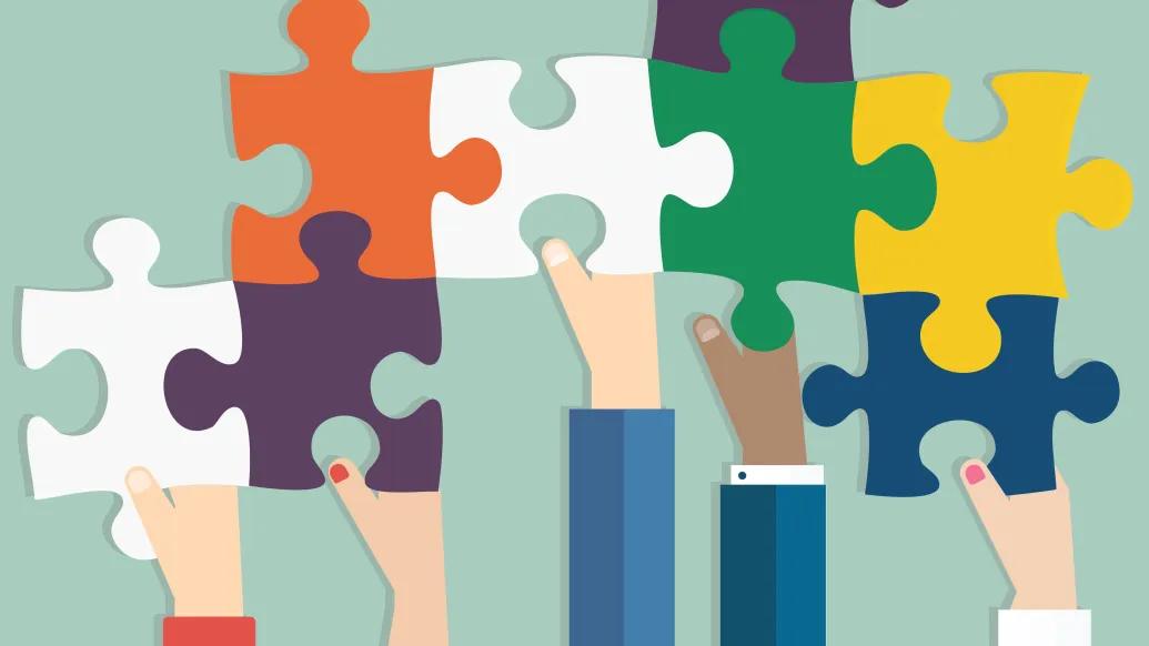 Hands working together to complete a puzzle representing the palliative care process