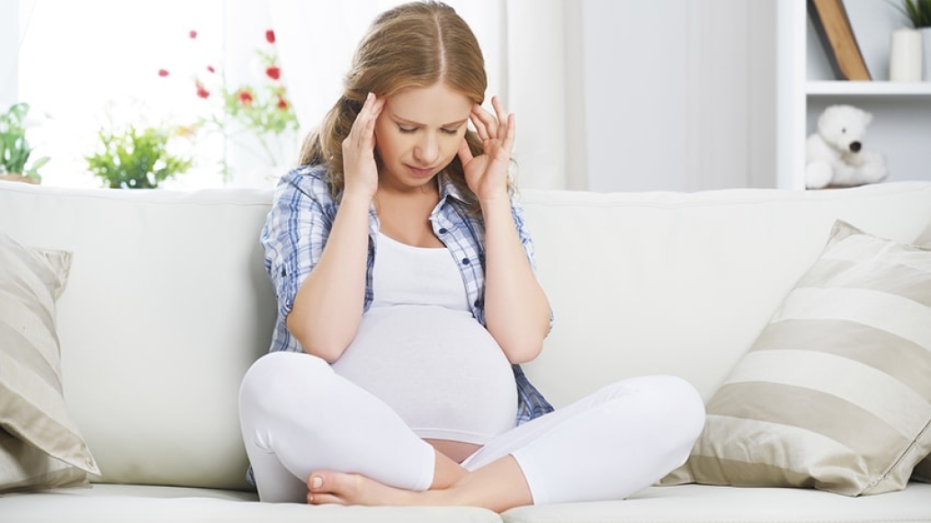 Woman with headache symptoms during pregnancy