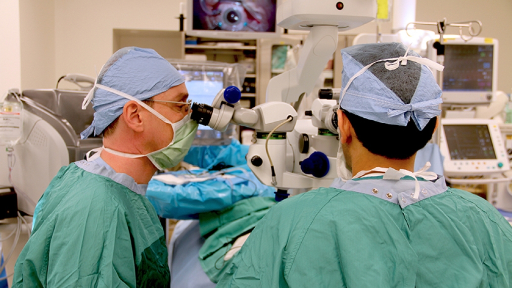 Two ophthalmologists performing retinal detachment surgery