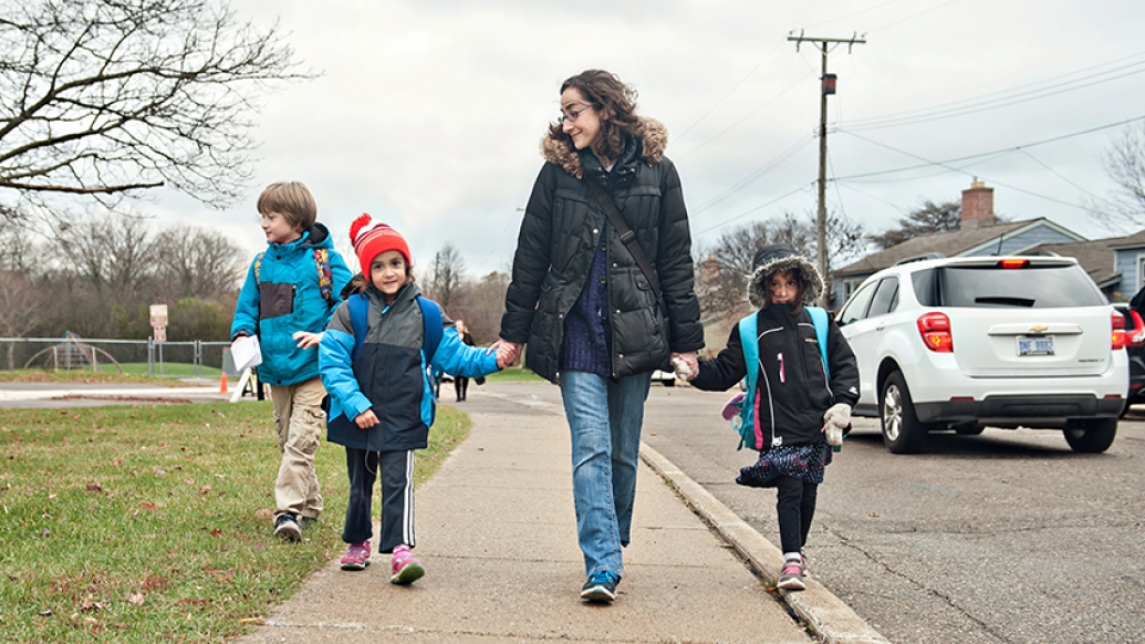 Tori and her three children walking to school