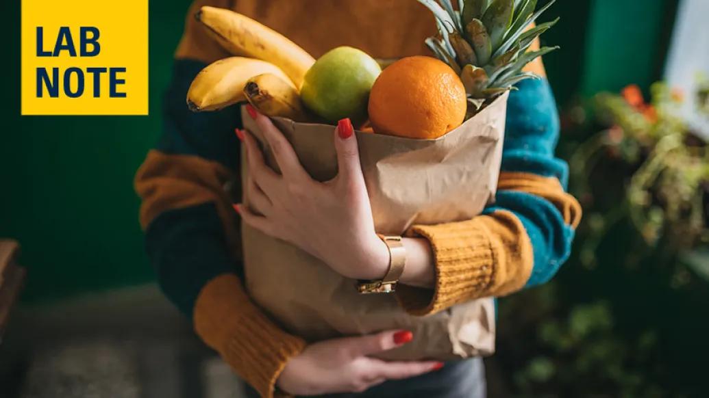 woman holding groceries in bag
