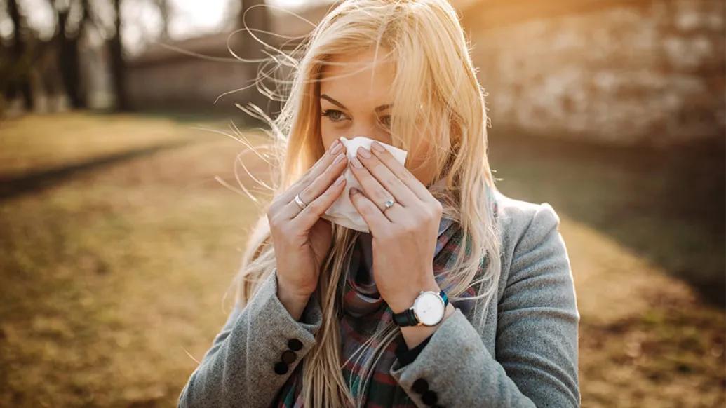 woman blowing her nose