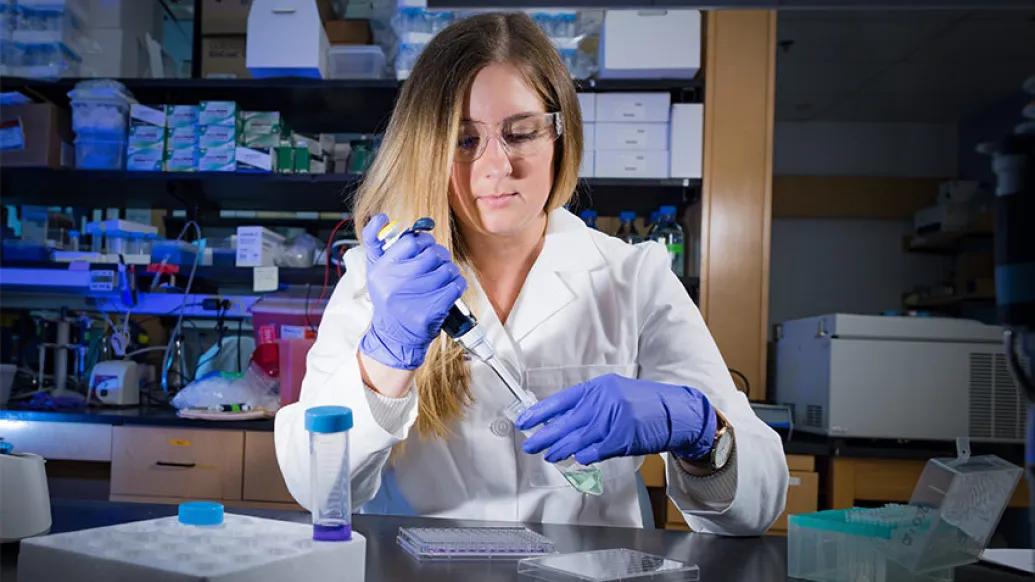 women scientist gloves laboratory vial 