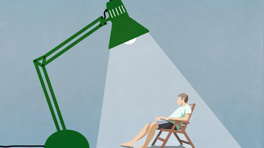 cartoon man under spotlight of green lamp sitting in chair