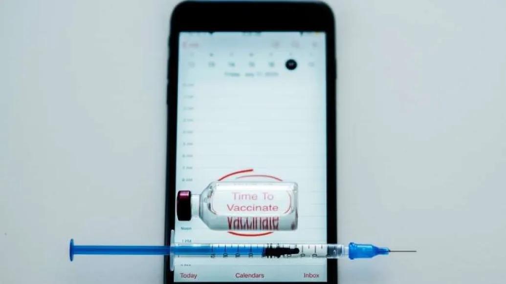 cell phone with vaccine bottle
