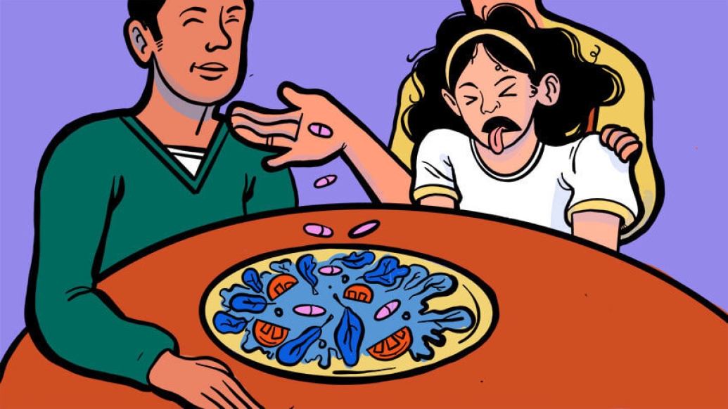 Father and daughter sitting at table. Girl making face at blue leafy tomato dish.