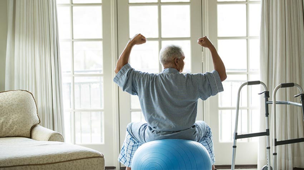 Elderly man working out at home
