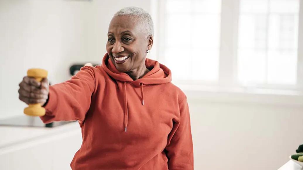 Elderly women exercise with hand weights