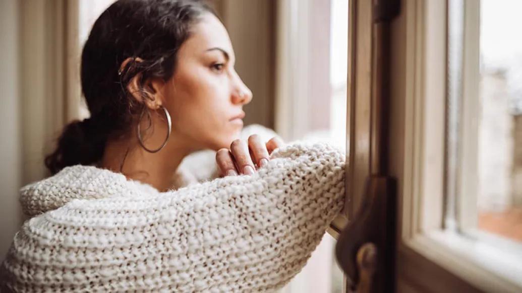 Female looking out window