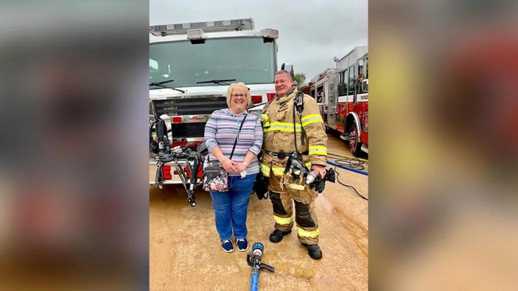 Firefighter in front of fire truck