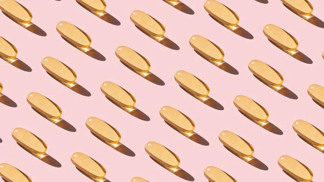 Fish oil pills on pink background