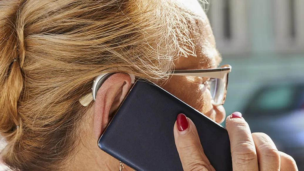 Women on cell phone with hearing aid
