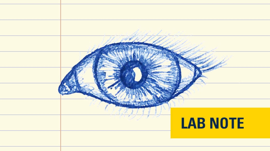 drawing in blue ink on lined paper of eye with lab note badge written out in yellow and navy blue bottom right corner