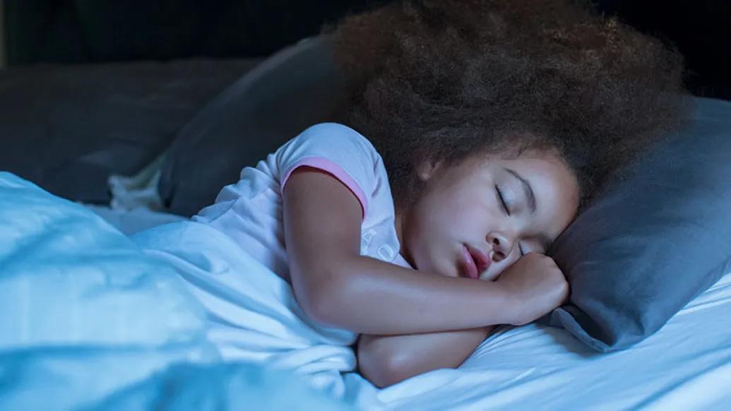 Little girl sleeping in bed