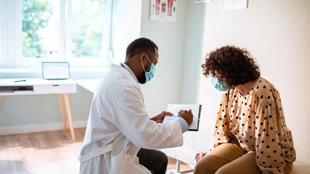 male doctor showing woman info
