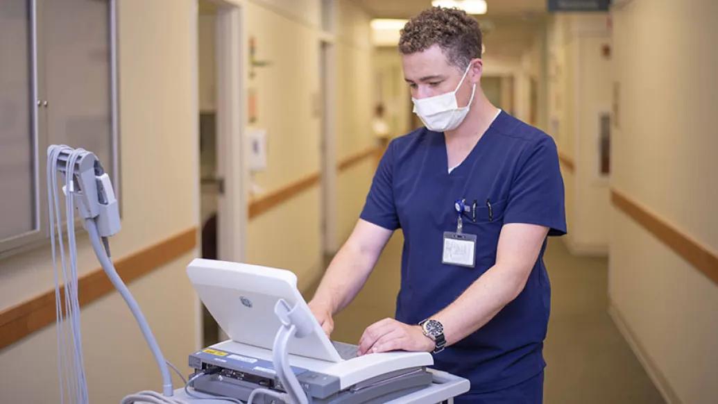 medical assistant in blue scrubs