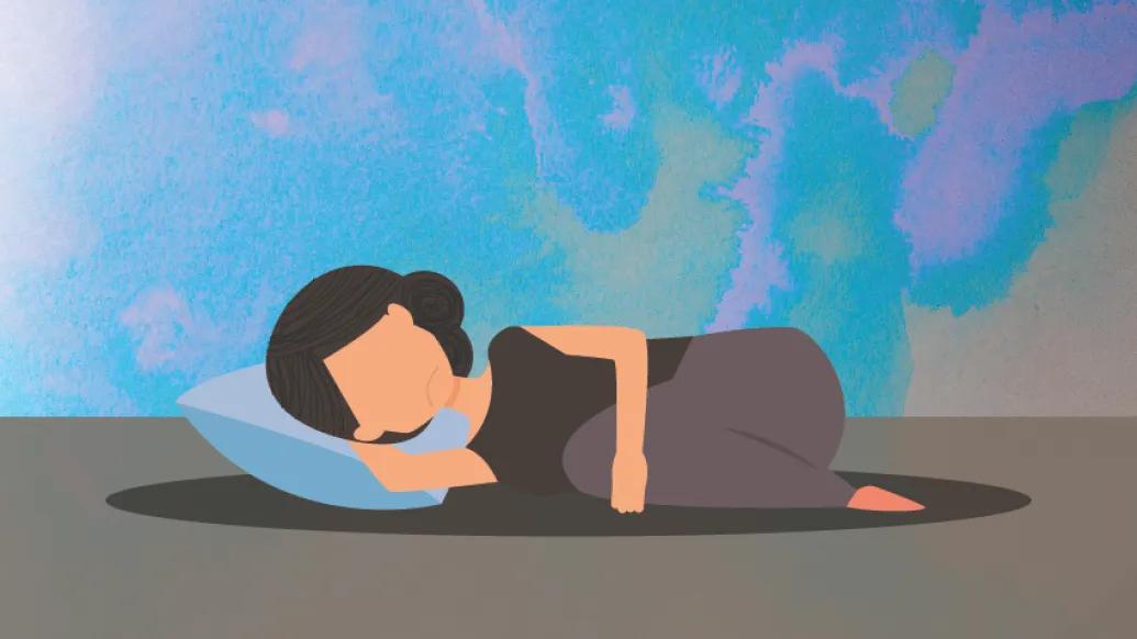 woman laying on floor on pillow holding stomach sad