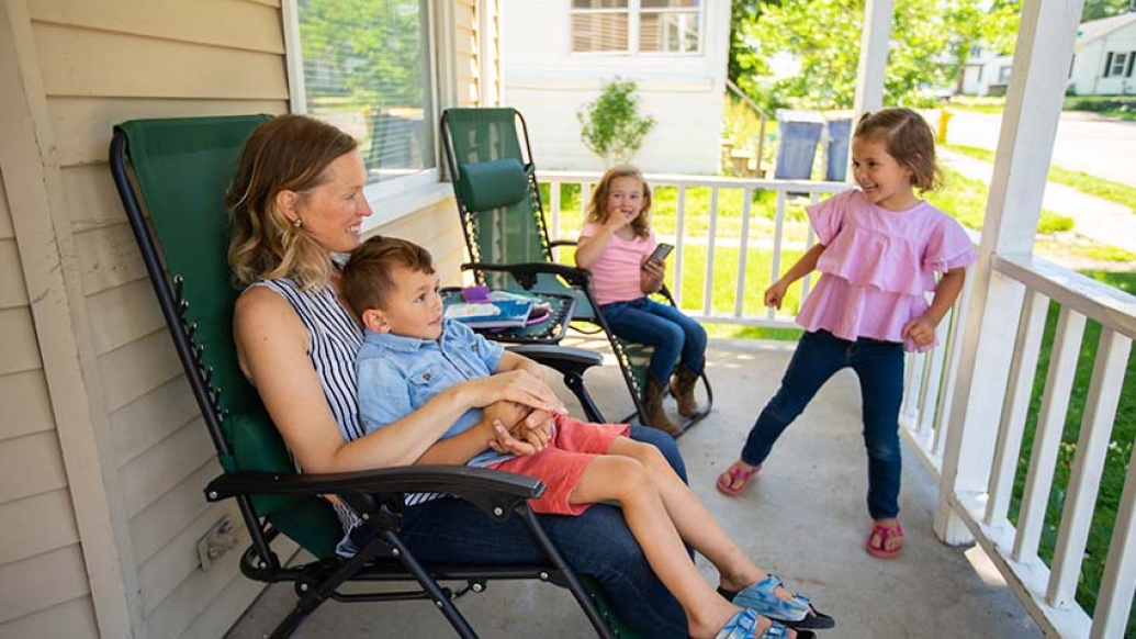 mom and children on front porch playing