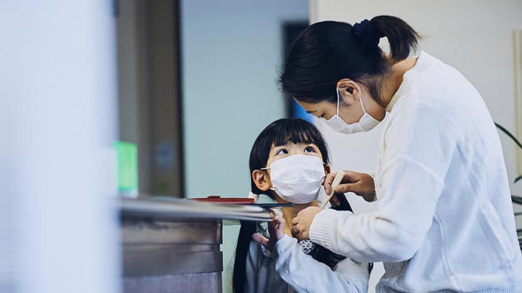 Mother and child with masks at doctors