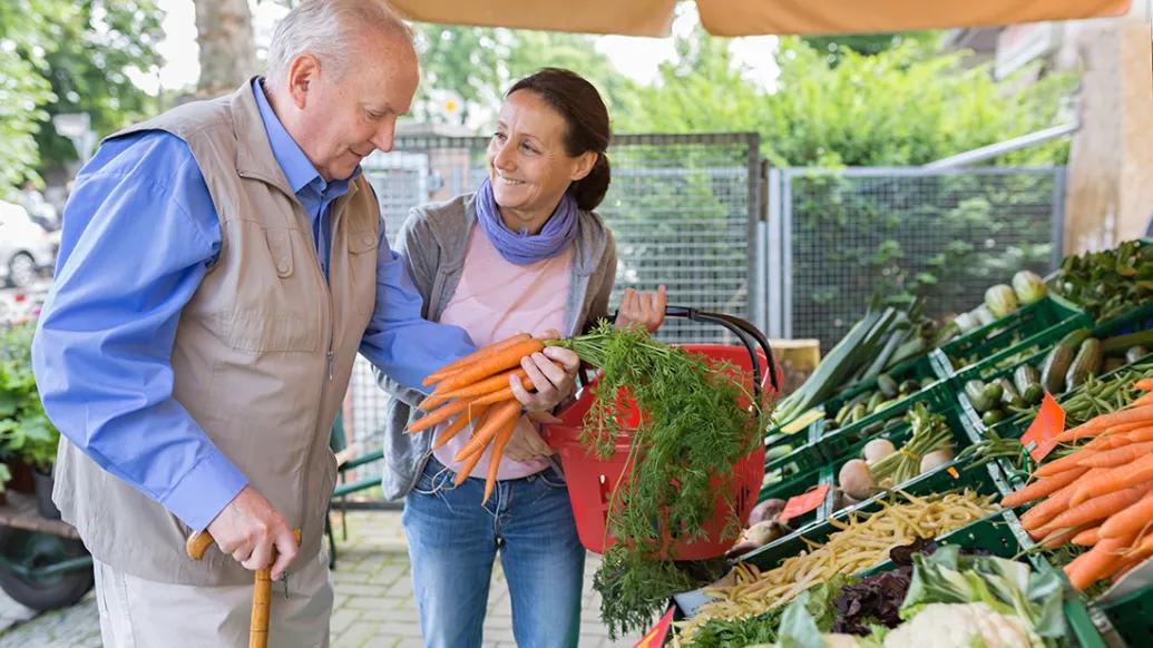 older adult at farmers market caregiver