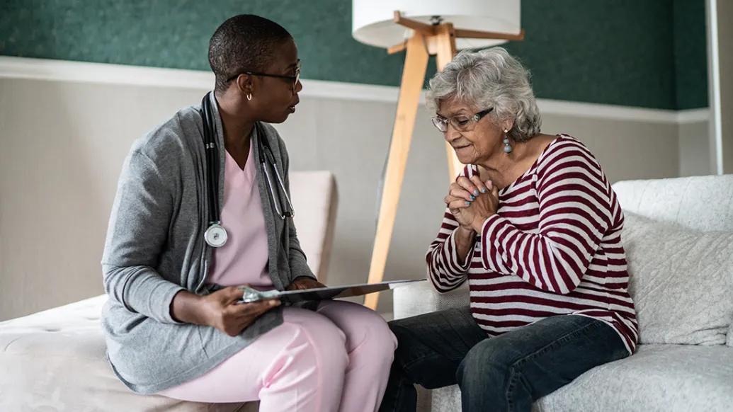 older woman speaking to care provider low