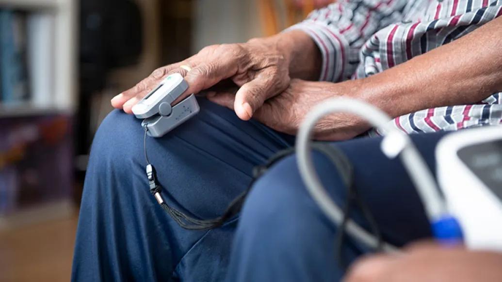 older person getting oxygen reading