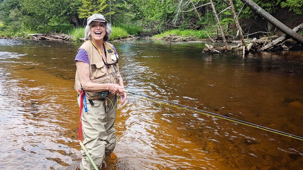 Carol fly fishing on the Maple River.