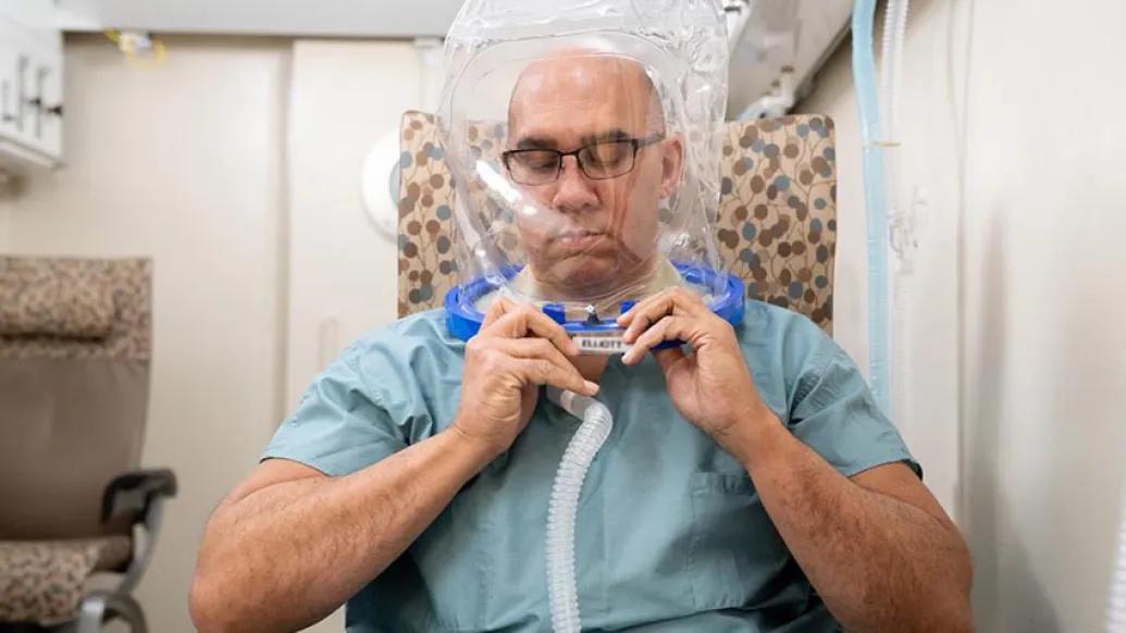 person with hyperbaric chamber mask on